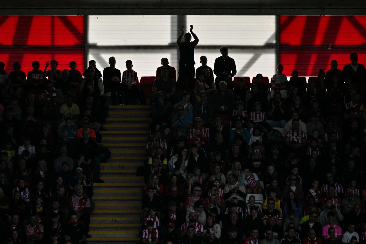 Supporters cheer during the English Premier League football match between Southampton and Manchester United at St Mary's Stadium in Southampton, southern England on September 14, 2024. (Photo by Glyn KIRK / AFP)