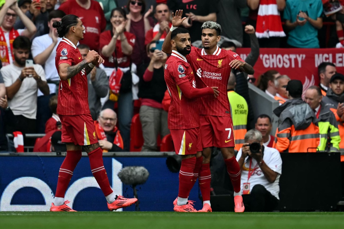 Liverpool's Colombian midfielder #07 Luis Diaz (R) celebrates with teammates after scoring a goal during the English Premier League football match between Liverpool and Bournemouth at Anfield in Liverpool, northwest England, on September 21, 2024. (Photo by Paul ELLIS / AFP)