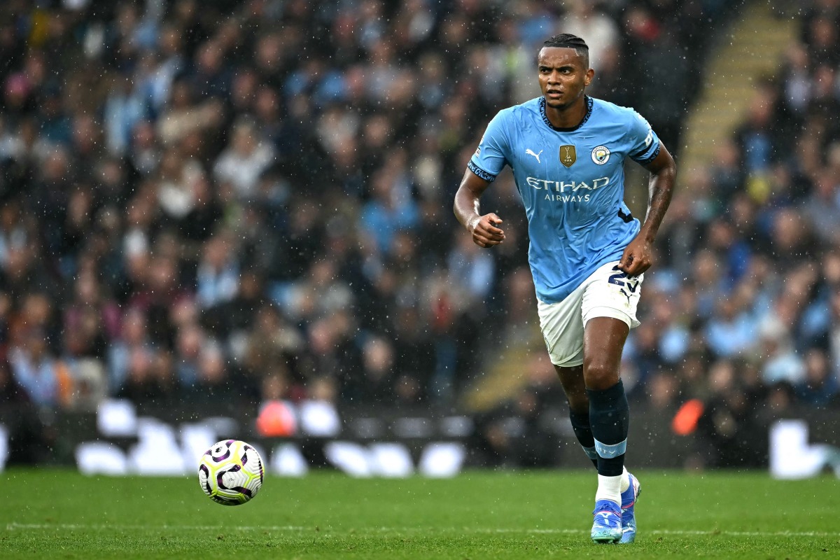 Manchester City's Swiss defender #25 Manuel Akanji runs with the ball during the English Premier League football match between Manchester City and Arsenal at the Etihad Stadium in Manchester, north west England, on September 22, 2024. (Photo by Paul ELLIS / AFP) /