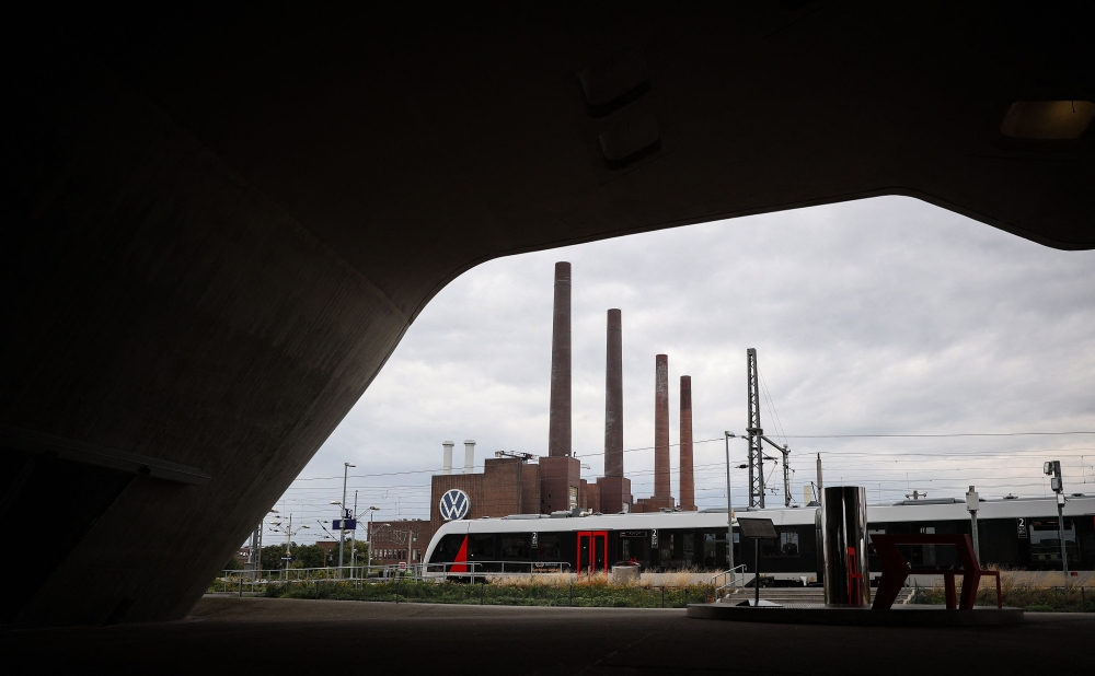 An RB (Regional railway) train leaves the main railway station in front of the power plant at the headquarters of German carmaker Volkswagen (VW) on September 25, 2024 in Wolfsburg, northern Germany. Photo by RONNY HARTMANN / AFP