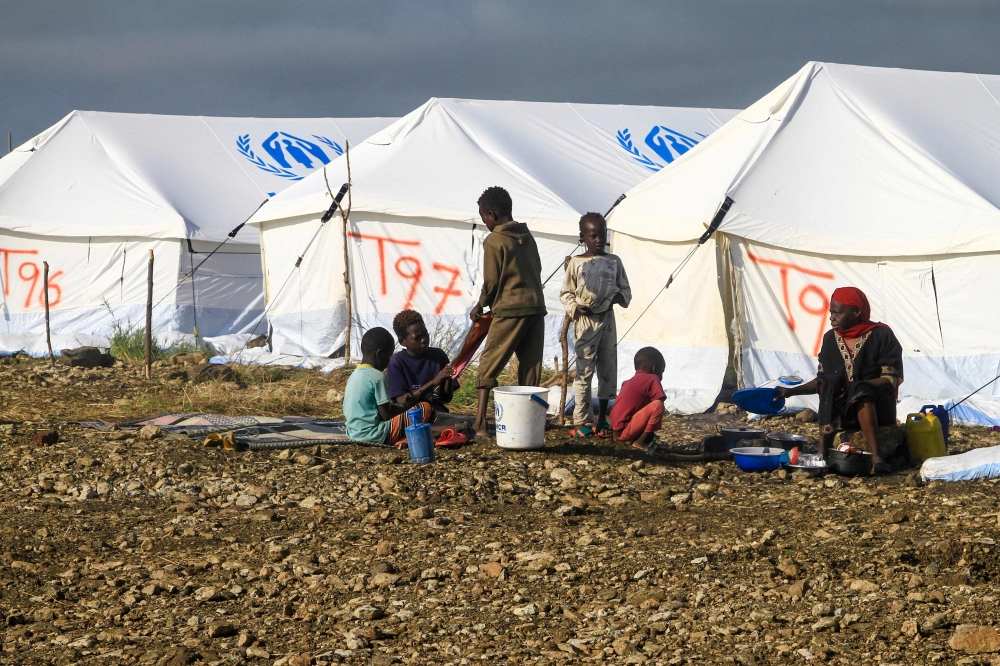 Displaced Sudanese who have returned from Ethiopia gather in a camp run by the United Nations Refugee Agency (UNHCR) in Sudan's border town of Gallabat in the eastern state of Gadaref on September 11, 2024. (Photo by Ebrahim Hamid / AFP)