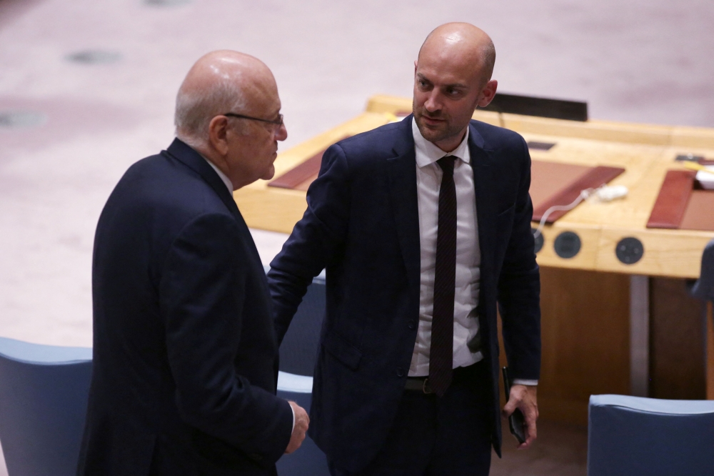Lebanon's Prime Minister Najib Mikati (L) speaks to French Minister of Foreign Affairs Jean-Noel Barrot during a a UN Security Council meeting at the United Nations headquarters in New York City on September 25, 2024. (Photo by Leonardo Munoz / AFP)
 