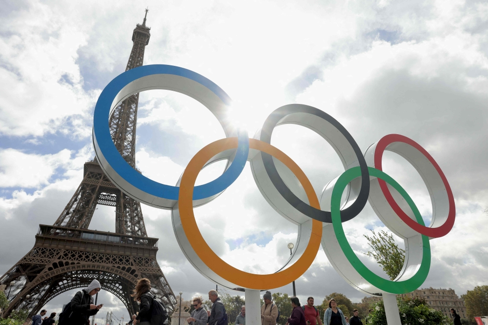 This photograph shows the Olympic rings displayed in front of the Eiffel Tower in Paris, on September 27, 2024. (Photo by Thomas SAMSON / AFP)