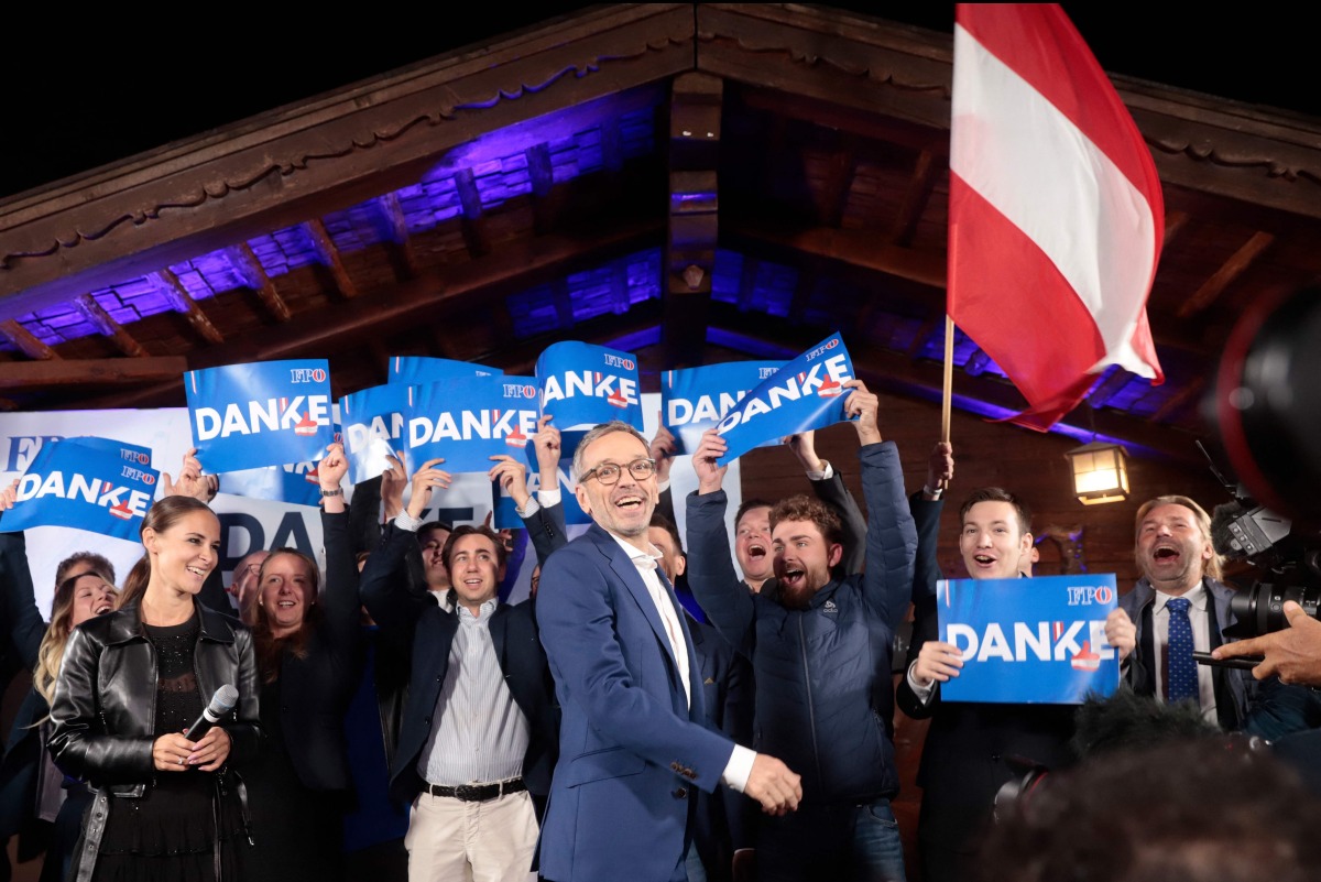 Herbert Kickl, leader and top candidate of right-wing populist Freedom Party of Austria (FPOe) is celebrated by supporters as he arrives at the party's election event after exit poll numbers where announced at the Stiegl-Ambulanz restaurant in Vienna, Austria on September 29, 2024, during Austria's general election. (Photo by Alex HALADA / AFP)
