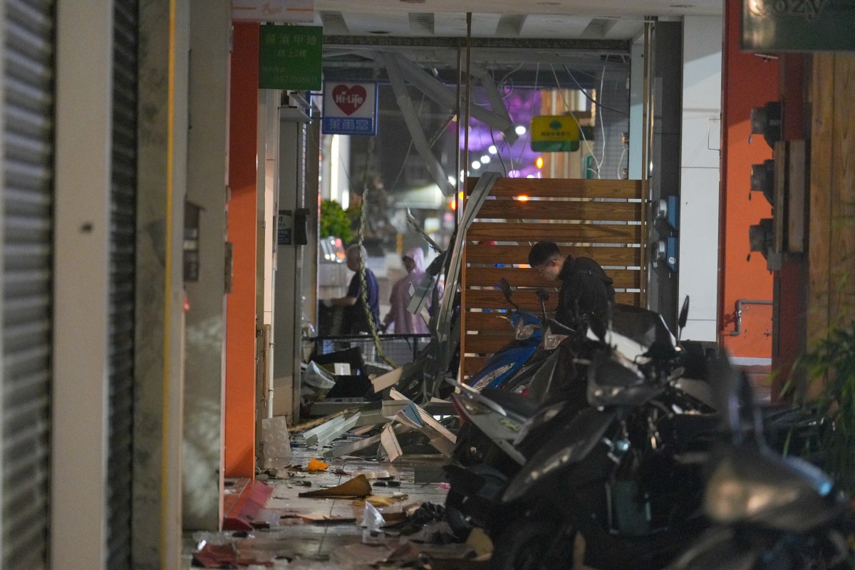 Convenience store staff clean the wreckage after Typhoon Krathon landed in Kaohsiung on October 3, 2024. Photo by WALID BERRAZEG / AFP