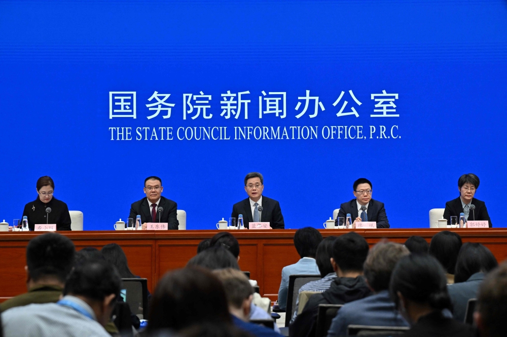 China's Finance Minister Lan Fon (C) speaks next to Vice Minister of Finance Wang Dongwei (2nd-L), Vice Minister of Finance Liao Min (2nd-R) and Vice Minister of Finance Guo Tingting (R) during a press conference in Beijing on October 12, 2024. (Photo by ADEK BERRY / AFP)
 
