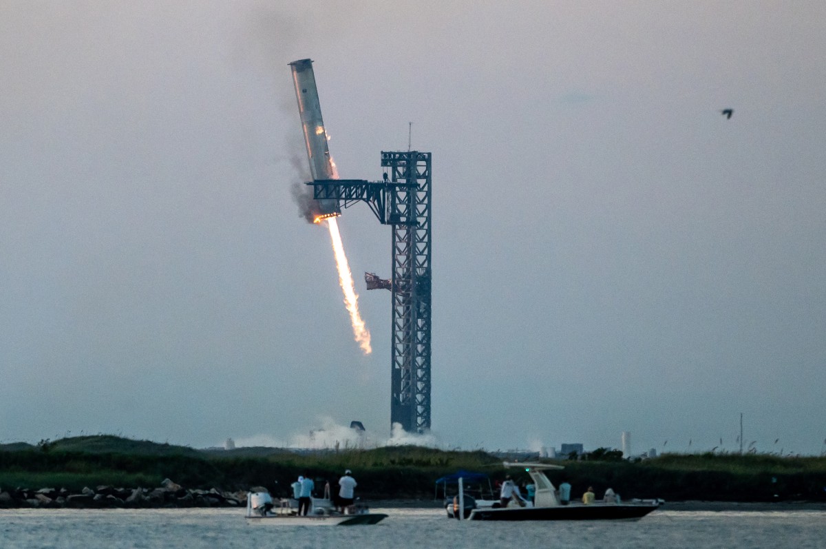 Starship's Super Heavy Booster is grappled at the launch pad in Starbase near Boca Chica, Texas, on October 13, 2024, during the Starship Flight 5 test. SpaceX successfully 
