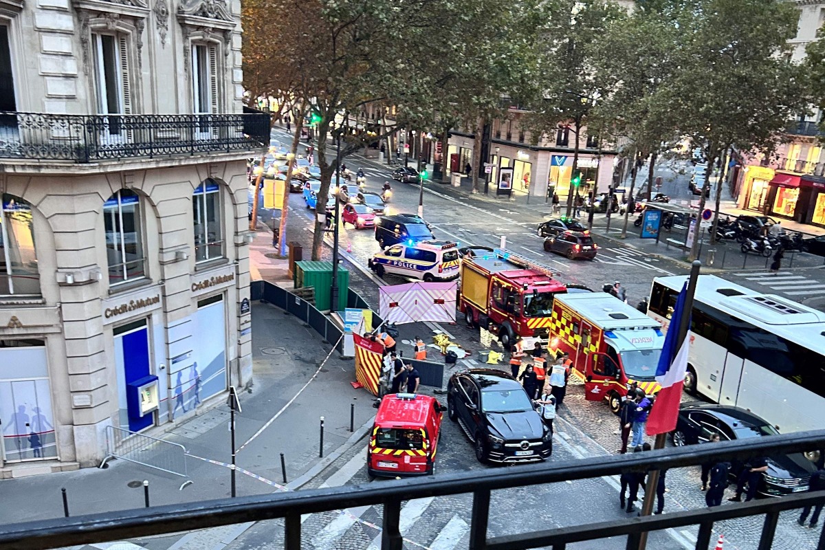 This photo taken on October 15, 2024 at the corner of Boulevard Malesherbes and rue Boissy d'Anglas near The Madeleine church shows first responders and police at the scene after a cyclist was run over by a SUV in Paris. (Photo by Veronique Lagarde / AFP)
