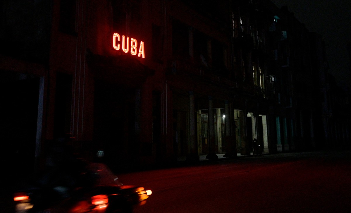 A sign enlightens a blacked out street during the second day of the nationwide blackout in Havana October 19, 2024. Photo by ADALBERTO ROQUE / AFP.
