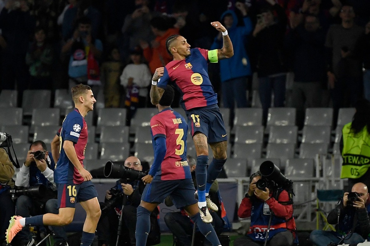 Barcelona's Brazilian forward #11 Raphinha (TOP) celebrates scoring the opening goal during the UEFA Champions League, league phase day 3 football match between FC Barcelona and FC Bayern Munich at the Estadi Olimpic Lluis Companys in Barcelona on October 23, 2024. (Photo by Josep LAGO / AFP)
