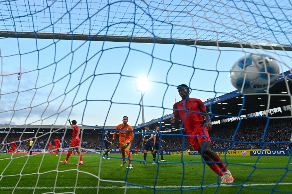 Bochum's German goalkeeper #27 Patrick Drewes (C) fails to save the 0-4 goal during the German first division Bundesliga football match between VfL Bochum and FC Bayern Munich in Bochum, western Germany, on October 27, 2024. (Photo by Ina Fassbender / AFP) 