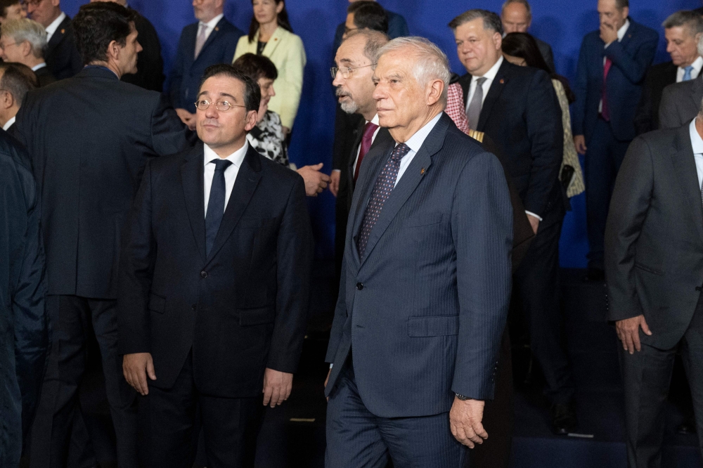 European Union High Representative for Foreign Affairs and Security Policy Josep Borrell (C), and Spain's Minister of Foreign Affairs Jose Manuel Albares (L) look on as members gather for a family photo at the start of the 9th regional forum of the Union for the Mediterranean (UfM), in Barcelona on October 28, 2024. (Photo by Josep Lago / AFP)