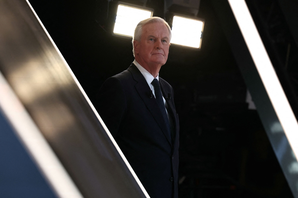 France's Prime Minister Michel Barnier looks on as he waits for entering the set of the political TV show 