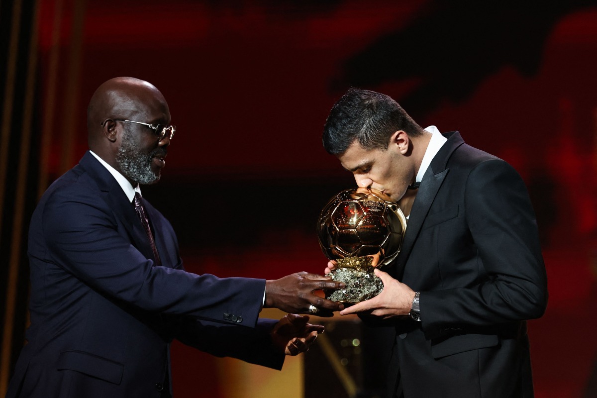 Manchester City's Spanish midfielder Rodri kisses the trophy as he receives the Ballon d'Or award during the 2024 Ballon d'Or France Football award ceremony at the Theatre du Chatelet in Paris on October 28, 2024. (Photo by FRANCK FIFE / AFP)
