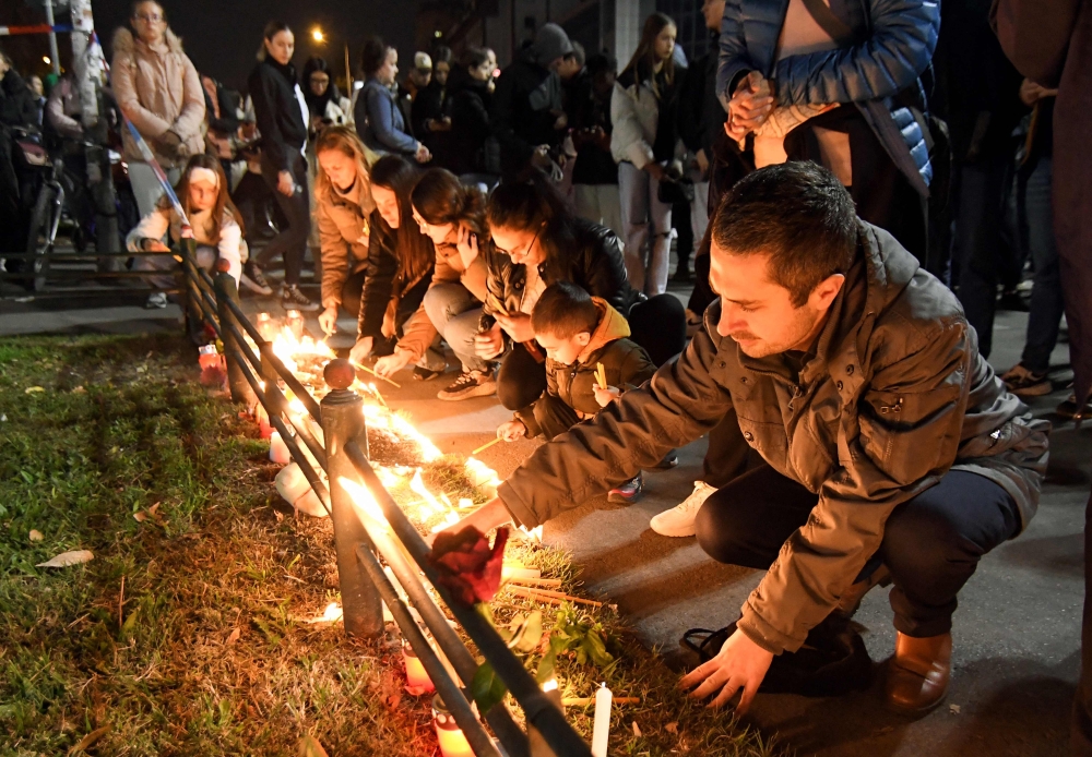 Local residents light candles near the train station in the northern Serbian city of Novi Sad on November 2, 2024, the day after an outdoor concrete roof of the station collapsed. Photo by NENAD MIHAJLOVIC / AFP