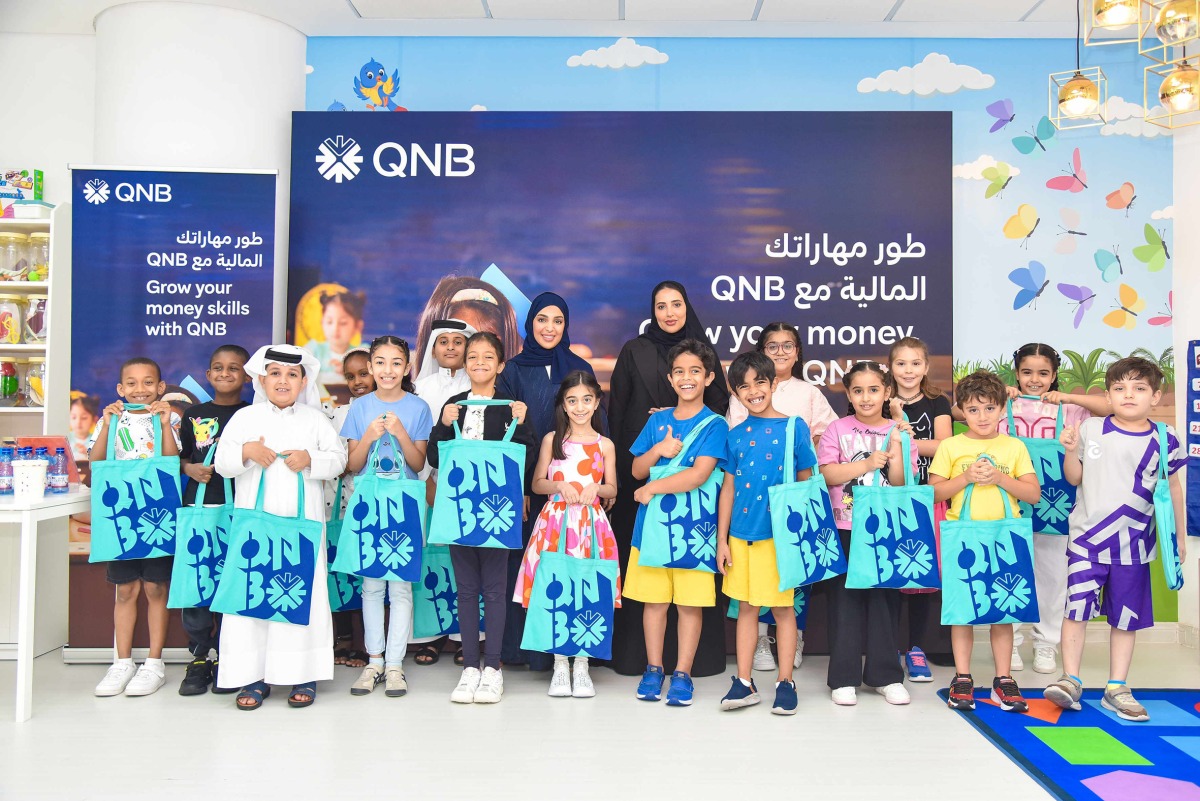 QNB officials pose for a group photo with participants during the Financial Literacy Autumn Camp for kids.