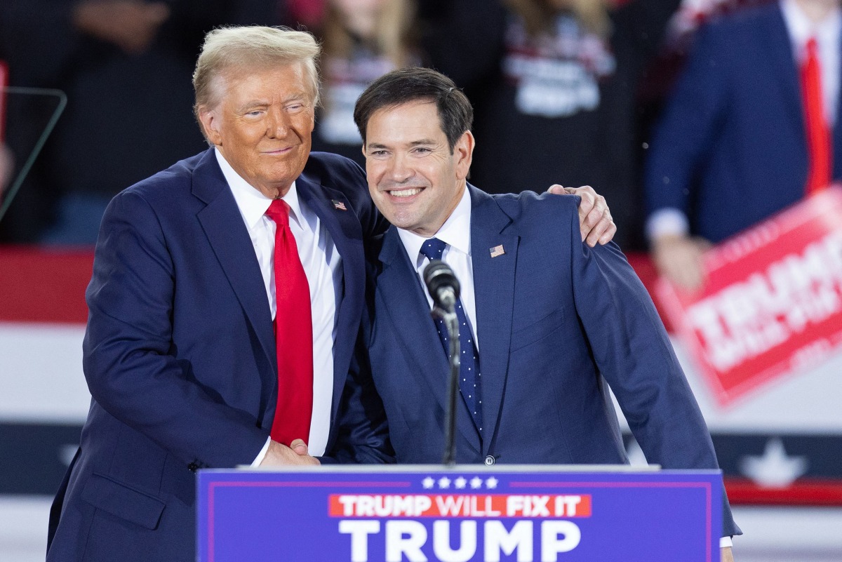 (FILES) Former US President and Republican presidential candidate Donald Trump greets Senator Marco Rubio, Republican of Florida, during a campaign rally at the J.S. Dorton Arena in Raleigh, North Carolina, on November 4, 2024. (Photo by Ryan M. Kelly / AFP)
