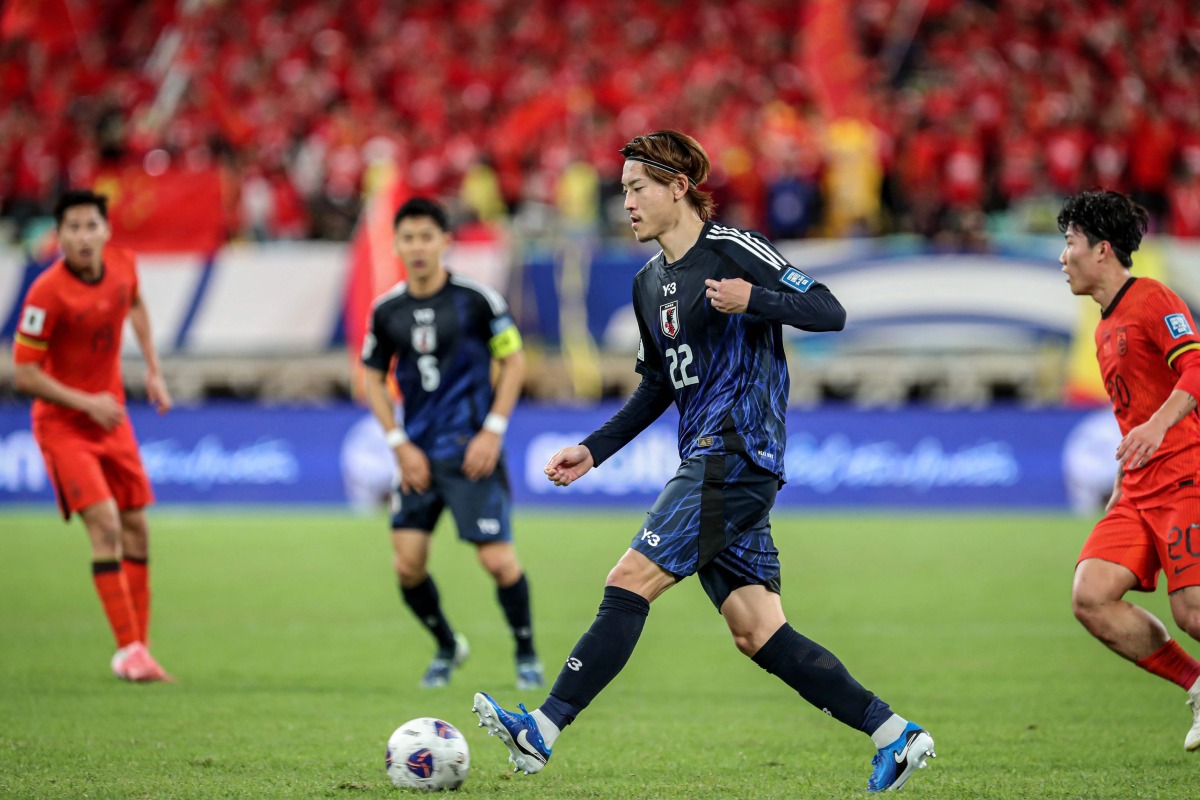 Japan's Ayumu Seko (2R) controls the ball during the 2026 FIFA World Cup qualification football match between China and Japan in Xiamen, in southeastern China's Fujian province on November 19, 2024. (Photo by STRINGER / AFP)