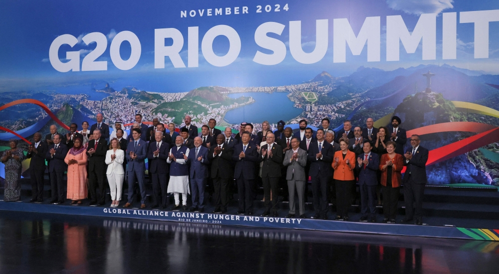 World leaders gather for a group photo on the second day of the G20 Summit in Rio de Janeiro, Brazil, on November 19, 2024. (Photo by Leah Millis / POOL / AFP)

