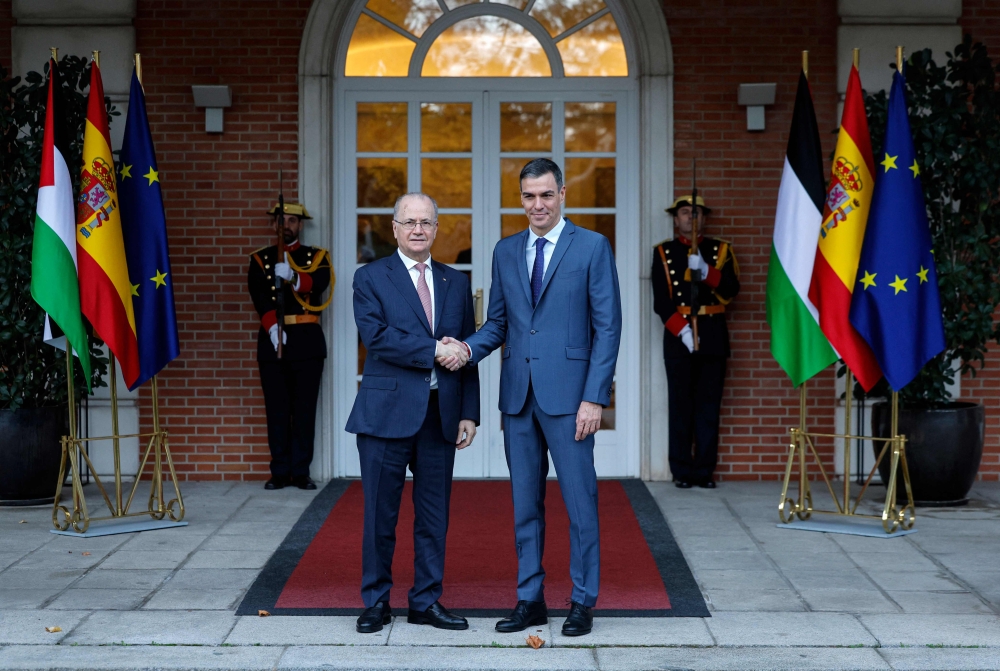 Spain's Prime Minister Pedro Sanchez (right) shakes hands with Palestinian prime minister Mohammad Mustafa before their meeting at the Moncloa Palace in Madrid, on November 21, 2024. (Photo by Oscar Del Pozo / AFP)