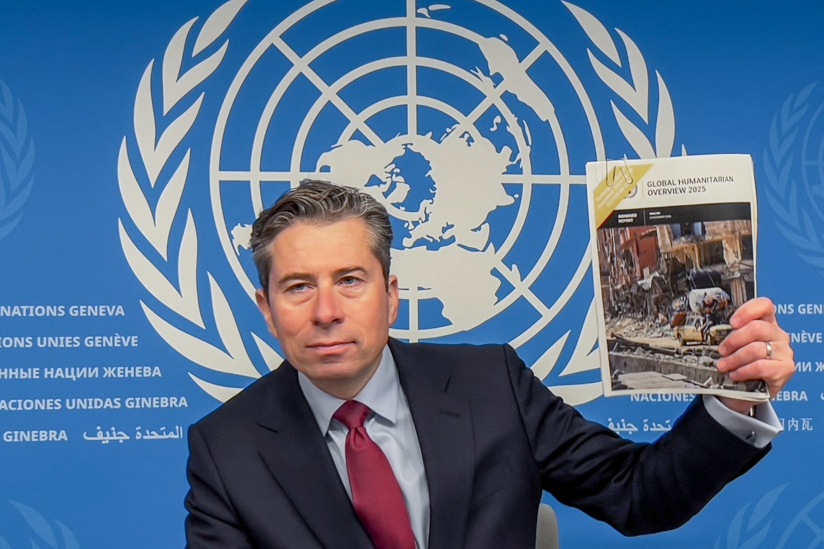 Humanitarian Affairs and Emergency Relief Coordinator (OCHA) Under-Secretary-General Tom Fletcher holds the Global Humanitarian Overwiew 2025 report during a press conference in Geneva on December 3, 2024. Photo by Elodie LE MAOU / AFP.
