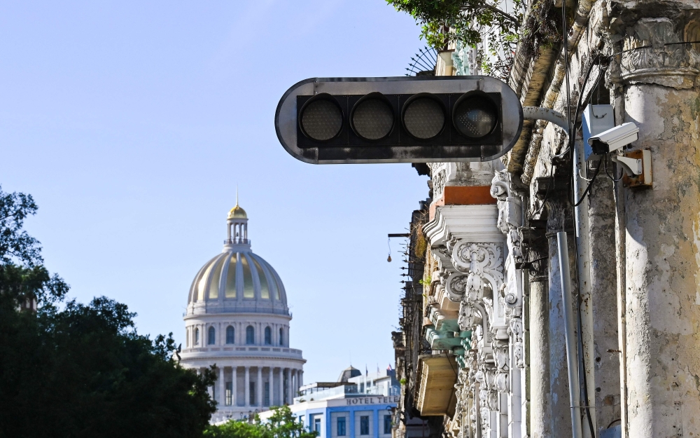 A blacked out traffic light is pictured after a power outage in Havana on December 4, 2024. (Photo by Yamil Lage / AFP)