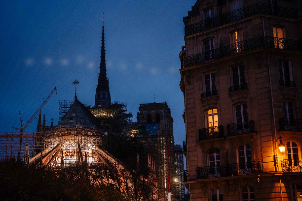This photograph shows the Notre-Dame de Paris cathedral illuminated in Paris on December 4, 2024, before its reopening on December 7, 2024. (Photo by Dimitar DILKOFF / AFP)
