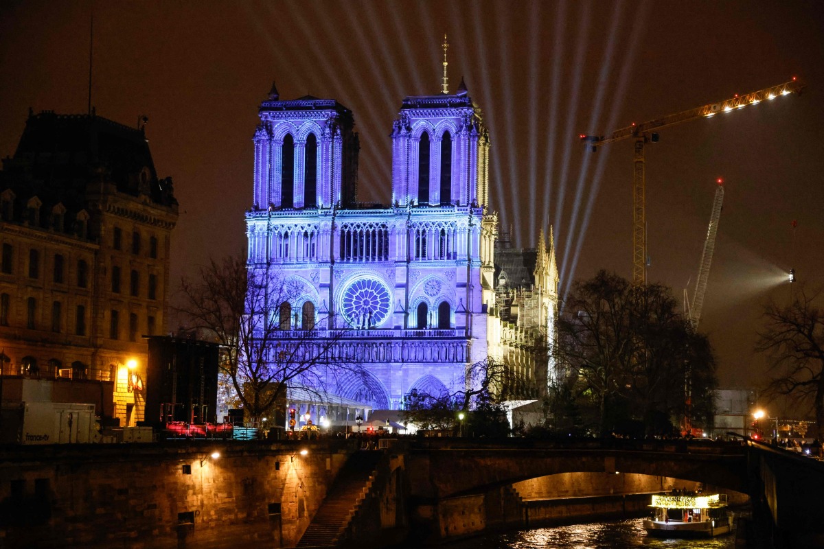 This photograph shows video mapping on the facade of Notre-Dame de Paris cathedral a few days before its reopening after reconstruction following the fire on April 4, 2019 when it was devastated, in Paris on December 5, 2024. Photo by Ludovic MARIN / AFP