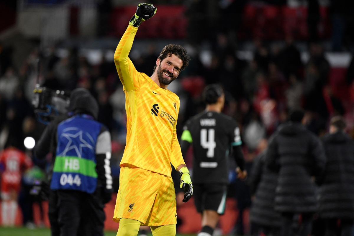 Liverpool's Brazilian goalkeeper #01 Alisson Becker celebrates at the end of the UEFA Champions League, league phase football match between Girona FC and Liverpool FC at the Montilivi stadium in Girona on December 10, 2024. (Photo by Josep LAGO / AFP)