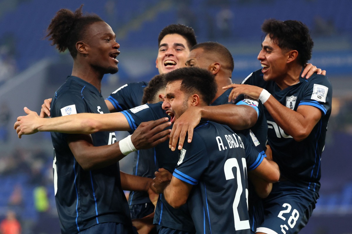Pachuca's Moroccan midfielder #11 Oussama Idrissi celebrates with teammates after scoring his team's first goal during the 2024 FIFA Intercontinental Cup football match between Brazil's Botafogo and Mexico's Pachuca at Stadium 974 in Doha on December 11, 2024. (Photo by Karim Jaafar / AFP)