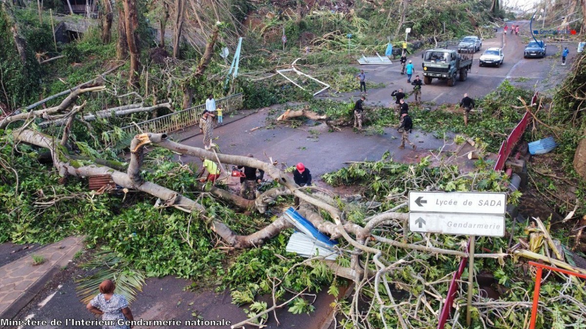 This undated handout photograph taken in the wake of Cyclone Chido and released by the Gendarmerie Nationale on December 17, 2024 shows French Gendarme clearing a fallen tree on a road at an undisclosed location on the French Indian Ocean territory of Mayotte. Photo by Handout / GENDARMERIE NATIONALE / AFP.