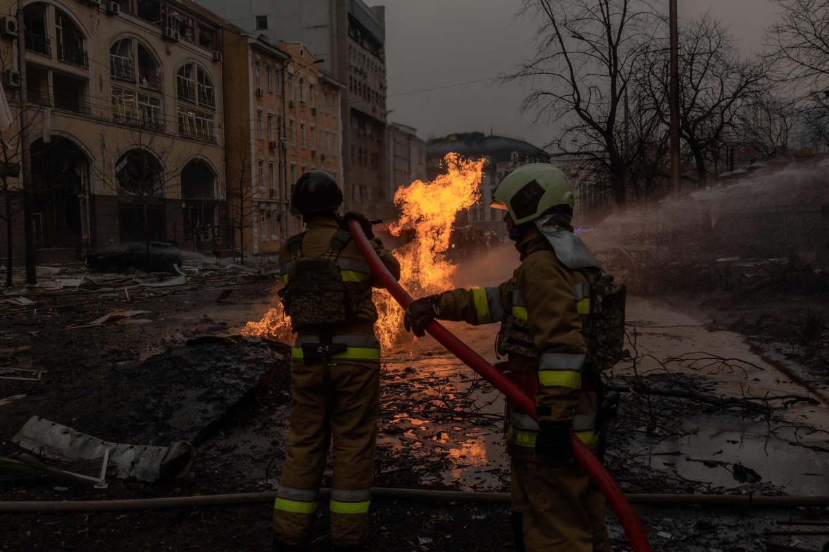 Ukrainian firefighters try to extinguish a fire on the site of a Russian missile attack in Kyiv on December 20, 2024, amid the Russian invasion in Ukraine. (Photo by Roman PILIPEY / AFP)