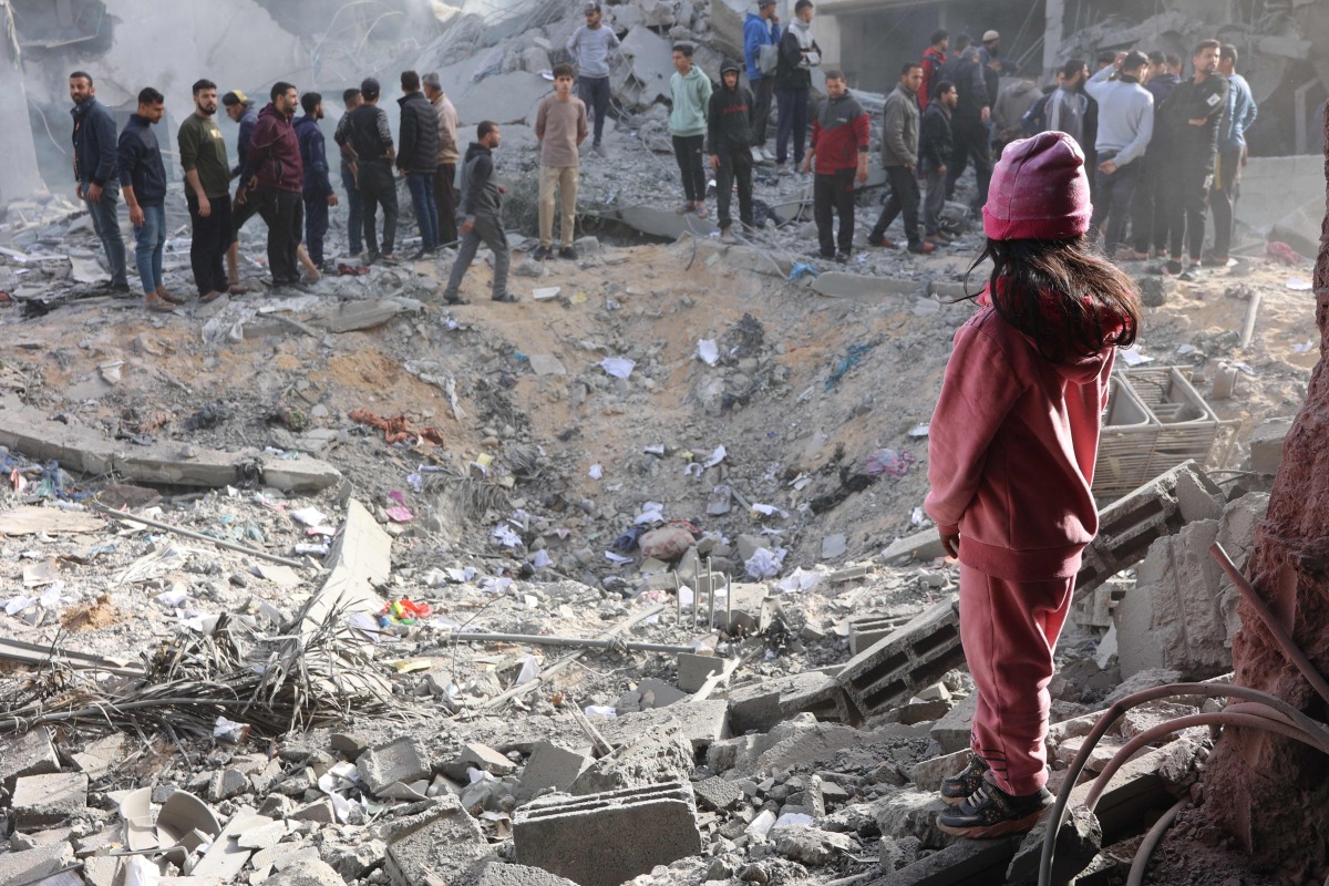 Civilians check the site of an Israeli strike in a residential area in the Tuffah neighbourhood, east of Gaza City, on December 26, 2024. Photo by Omar AL-QATTAA / AFP