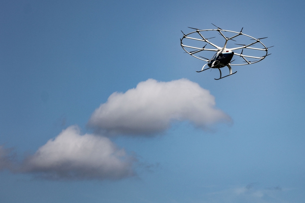 (Files) A Volocopter Volocity air taxi is seen during a demonstration flight at the Saint-Cyr-l'Ecole airfield in Saint-Cyr-l'Ecole, France, on August 8, 2024. (Photo by Thibaud Moritz / AFP)