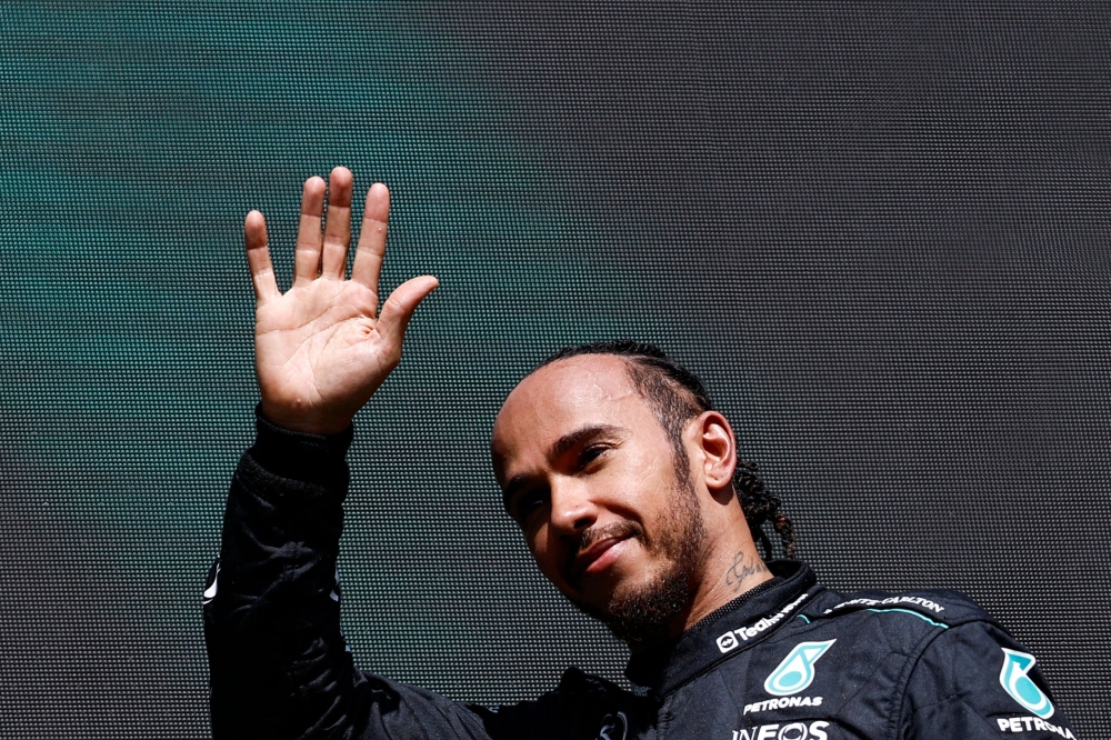 Mercedes' British driver Lewis Hamilton waves as he arrives for the podium ceremony after the Formula One Belgian Grand Prix at the Spa-Francorchamps Circuit in Spa on July 28, 2024. (Photo by SIMON WOHLFAHRT / AFP)