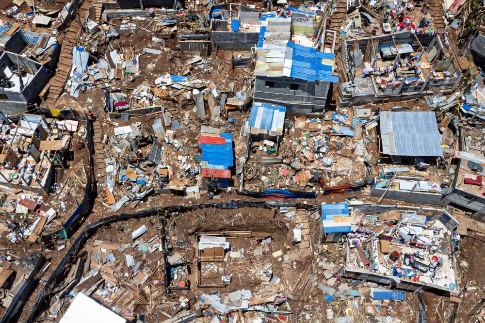 Files: This aerial view shows destroyed shelters and houses in the town of Vahibe, on the outskirts of Mamoudzou, on the French Indian Ocean territory of Mayotte, on December 24, 2024. (Photo by Patrick Meinhardt / AFP) 