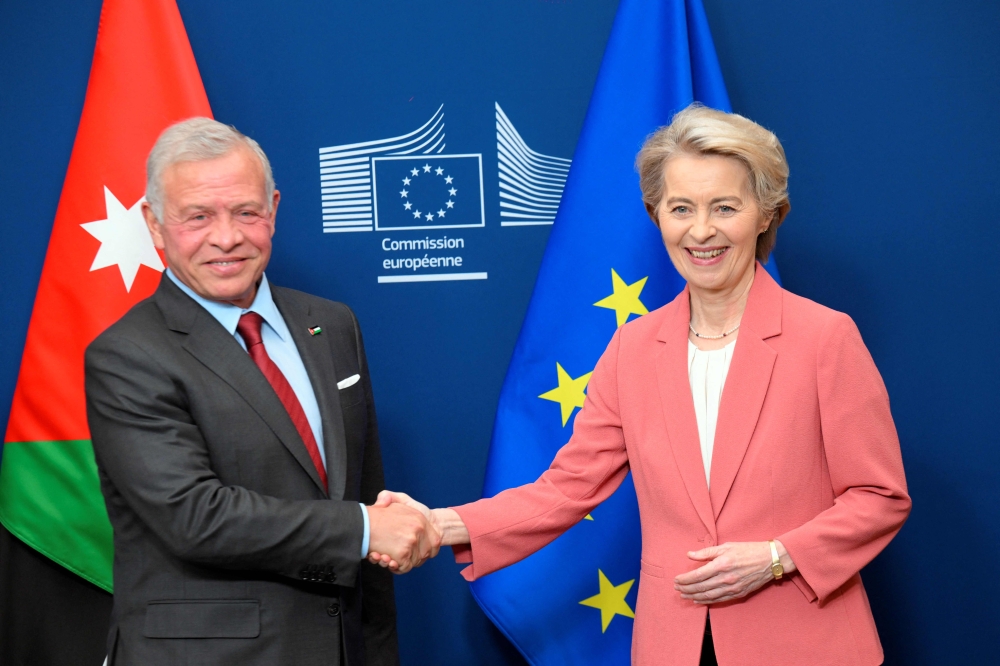 President of the European Commission Ursula von der Leyen (R) shakes hands with Jordan's King Abdullah II (L) before a meeting at the EU headquarters in Brussels on January 29, 2025. (Photo by Nicolas Tucat / AFP)
