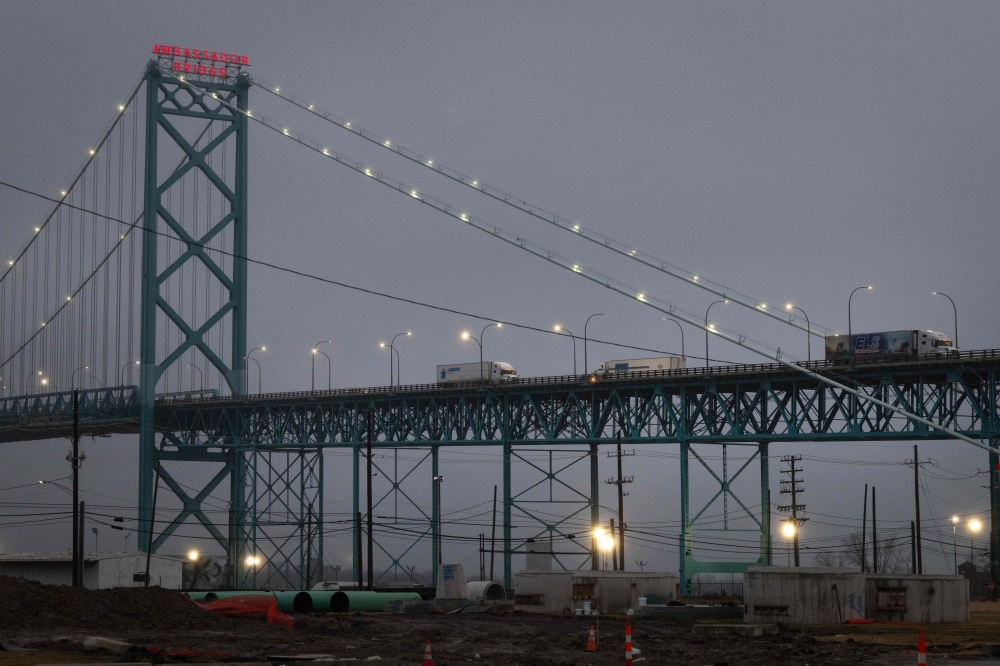 Trucks carry goods across the Ambassador Bridge from Canada into the United States on February 03, 2025 in Detroit, Michigan. Scott Olson/Getty Images/AFP