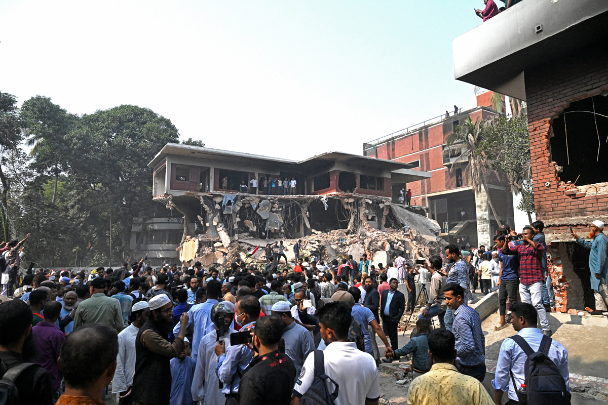 Onlookers gather after protesters stormed Bangabandhu Memorial Museum, the residence of Sheikh Mujibur Rahman, independent Bangladesh's first president and father of the country's ousted Prime Minister Sheikh Hasina, at Dhanmondi 32 in Dhaka on February 6, 2025. (Photo by Munir Uz Zaman / AFP)
