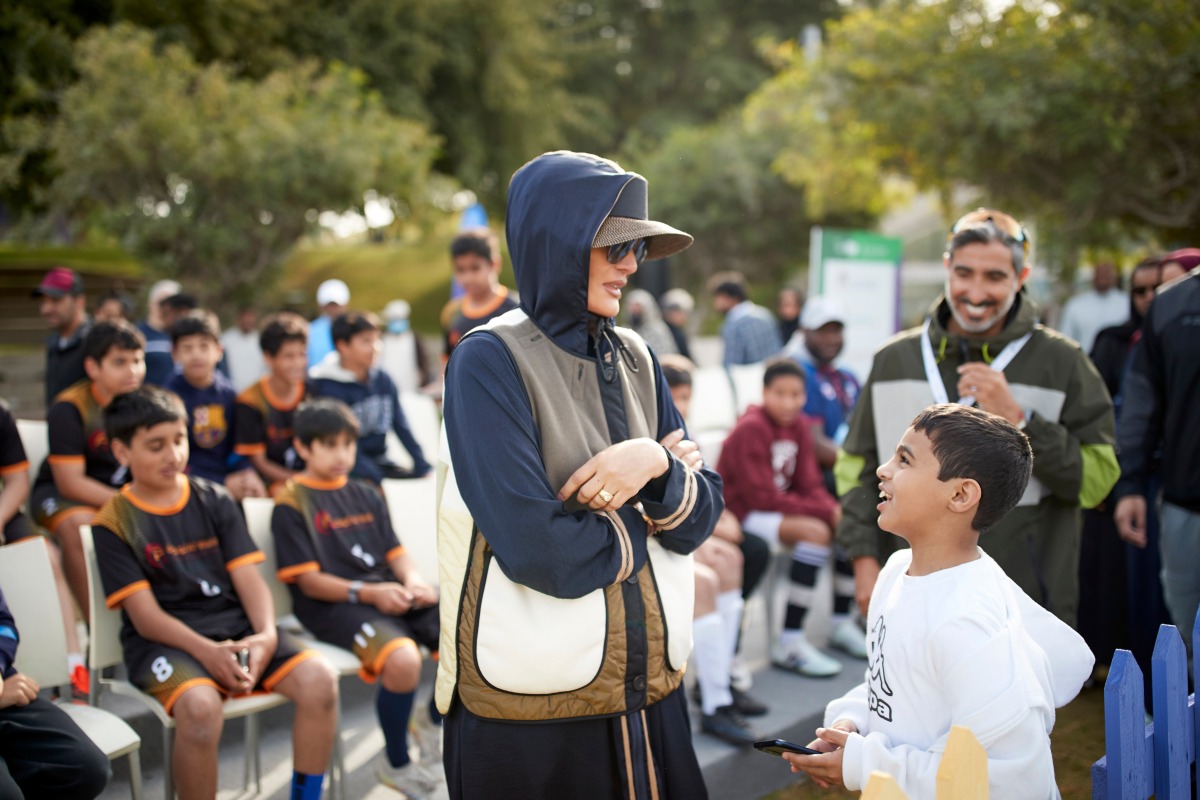 Chairperson of Qatar Foundation H H Sheikha Moza bint Nasser interacting with a child during National Sport Day (NSD) activities held yesterday in Education City.