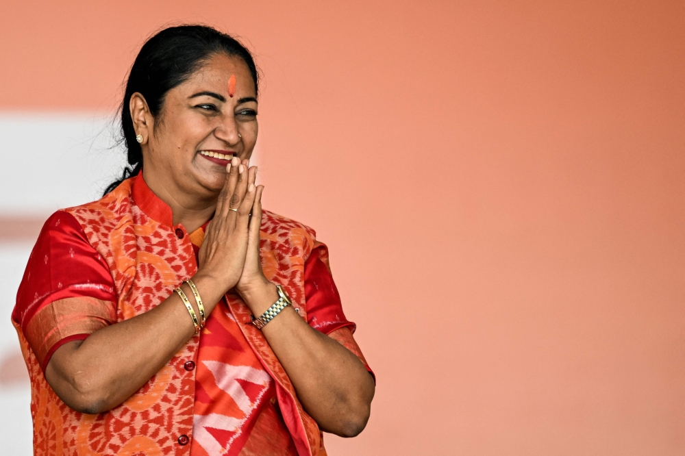 Newly elected Chief Minister of Delhi, Rekha Gupta, gestures after taking an oath during a swearing-in ceremony in New Delhi on February 20, 2025. (Photo by Sajjad Hussain / AFP)