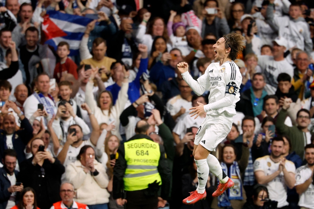 Real Madrid's Croatian midfielder #10 Luka Modric celebrates scoring the opening goal during the Spanish league football match between Real Madrid CF and Girona FC at Santiago Bernabeu Stadium in Madrid on February 23, 2025. (Photo by Pierre-Philippe Marcou / AFP)