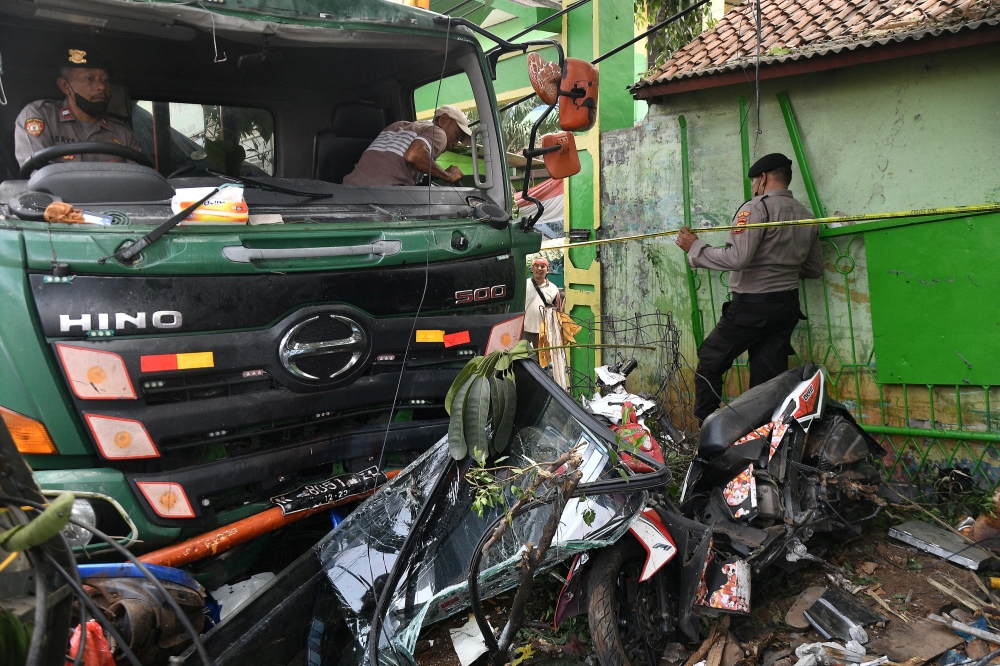 File photo for representational purposes only. Police officers try to move a damaged truck after an accident in Bekasi, on the outskirts of Jakarta, Indonesia, August 31, 2022, in this photo taken by Antara Foto. Antara Foto/Fakhri Hermansyah/ via REUTERS

