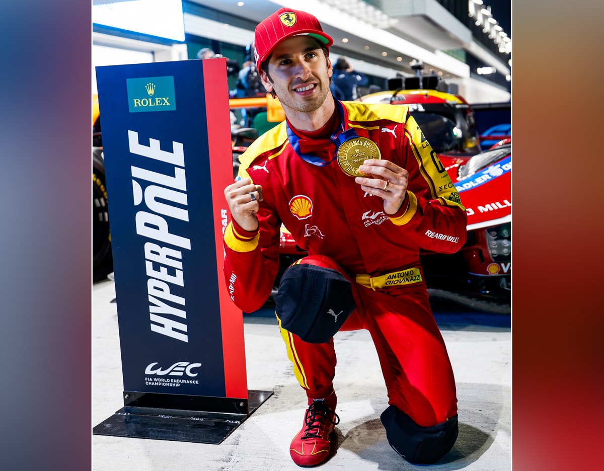 Ferrari's Italian driver Antonio Giovinazzi celebrates his pole position.