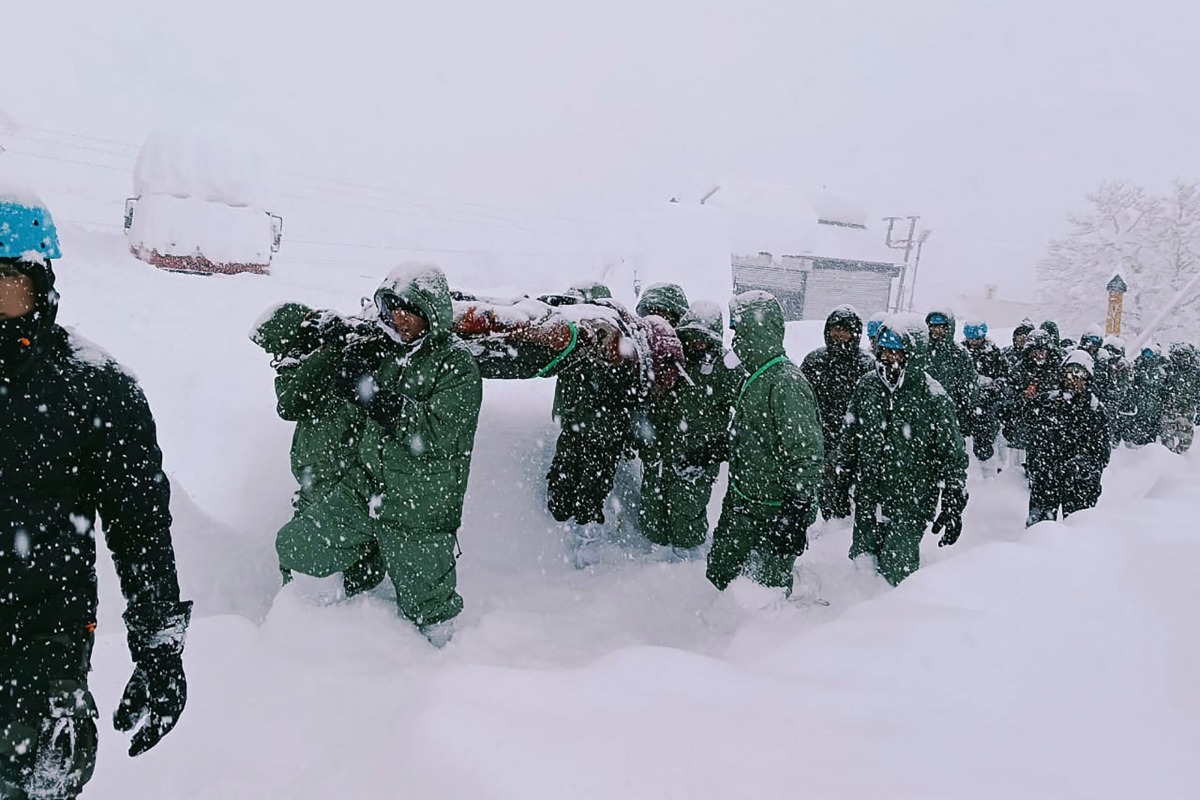In this handout photo taken and released by the State Disaster Response Force (SDRF) on February 28, 2025, rescuers carry Border Roads Organisation (BRO) workers after an avalanche near Mana village in Chamoli district. Photo by State Disaster Response Force (SDRF) / AFP