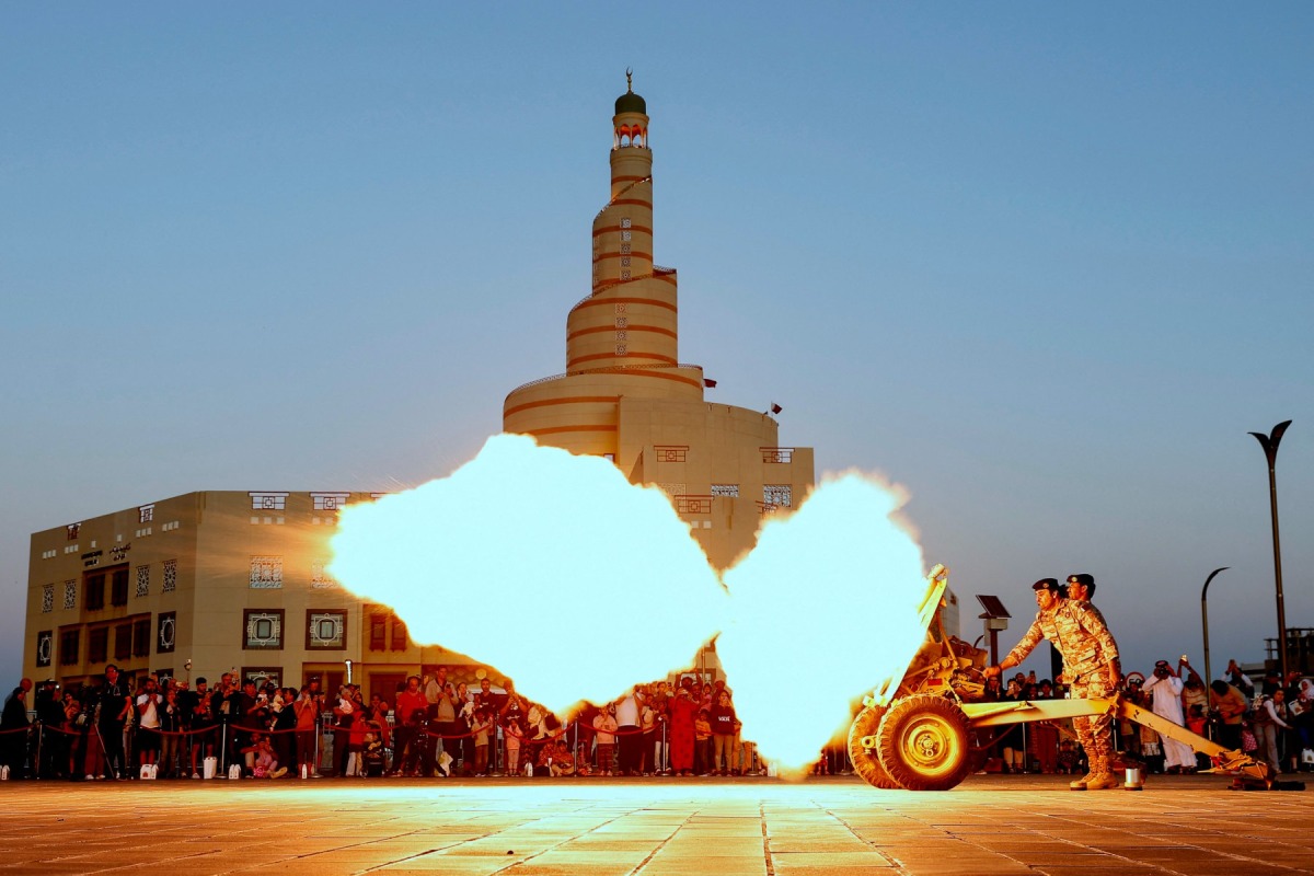 The 'iftar' cannon is fired to signal sunset and the end of fasting at Souq Waqif in Doha on March 12, 2024. Photo by Karim Jaafar / AFP.