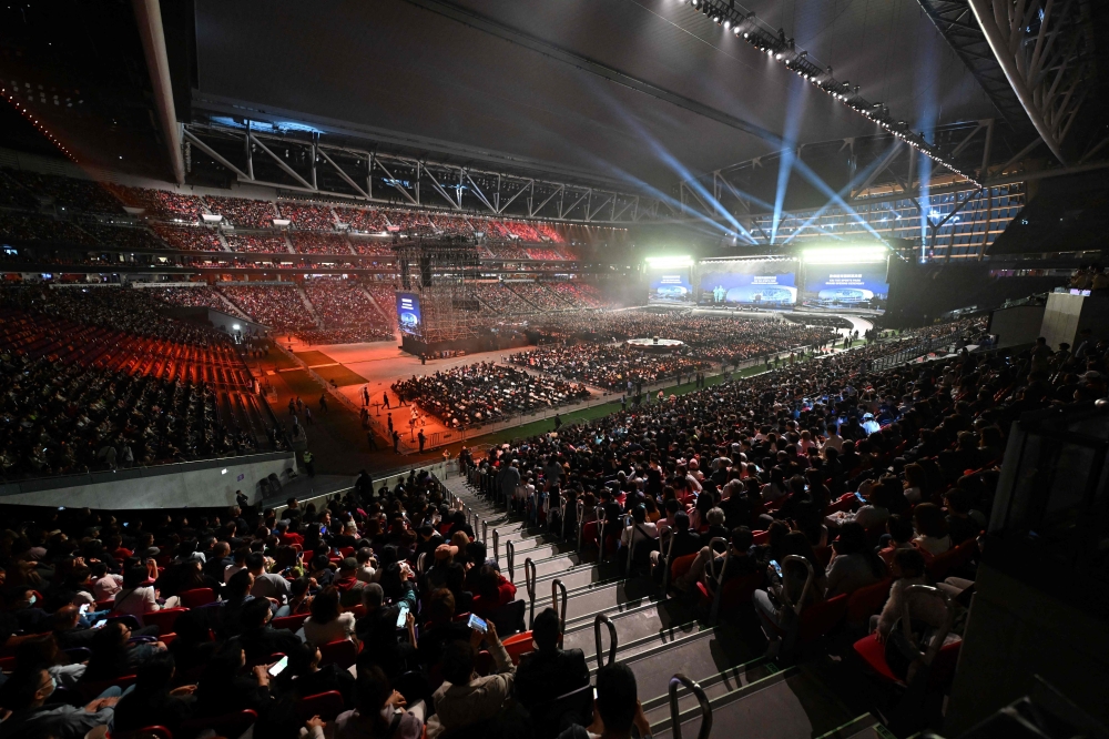 The crowd watches the opening ceremony of the Kai Tak Sports stadium on March 1, 2025. (Photo by Peter Parks / AFP)