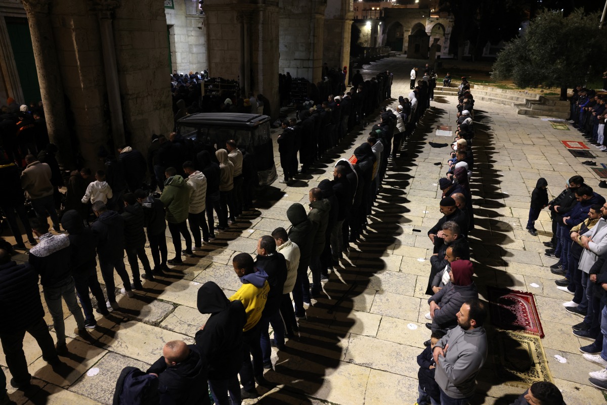 Palestinian devotees perform the evening 'Taraweeh' prayers at the Al Aqsa mosque compound in Jerusalem on February 28, 2025, on the eve of the Muslim holy fasting month of Ramadan. (Photo by AHMAD GHARABLI / AFP)