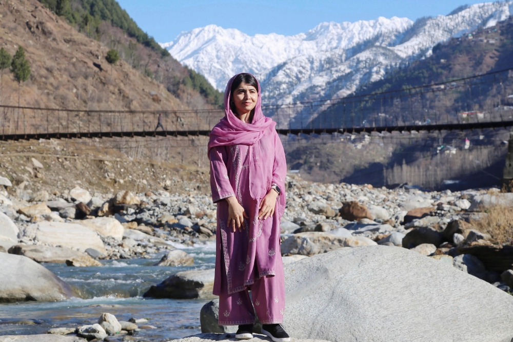 This handout picture taken and released by the Malala Fund on March 5, 2025, shows Nobel Peace Prize laureate and education activist Malala Yousafzai posing during a visit to her home village in Shangla.  (Photo by Handout / Malala Fund / AFP)