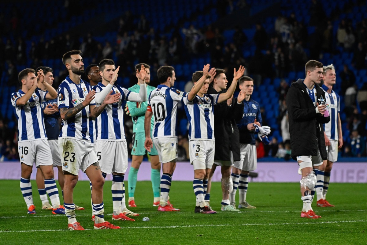 Real Sociedad players react at the end of the UEFA Europa League Round of 16 first let football match between Real Sociedad and Manchester United at Anoeta Stadium in San Sebastian on March 6, 2025. (Photo by ANDER GILLENEA / AFP)
